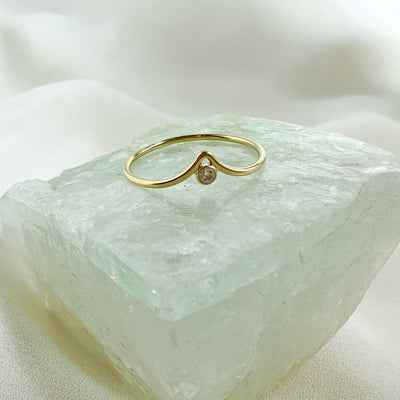 14K gold filled chevron shaped ring with white sparkly cubic Zirconia stone nestled into the centre point of the chevron peak. on aqua coloured gemstone 